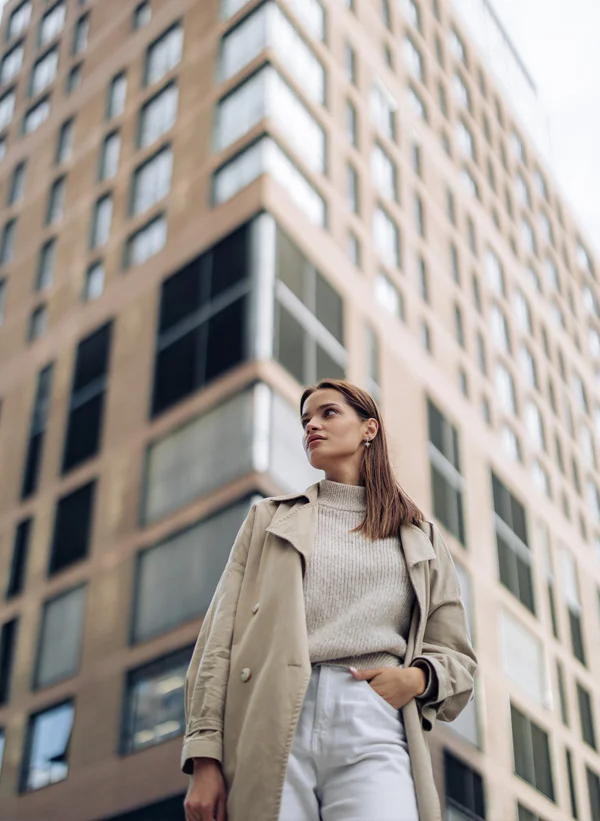 woman standing next to a building | Henderson Breast Reconstruction New York